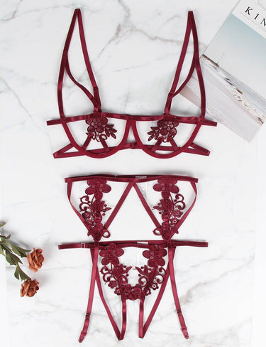 a pair of red lace garters sitting on top of a table